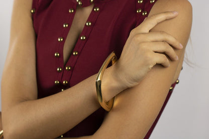 Rigid silver bracelet with golden triangle