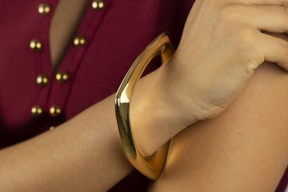Rigid silver bracelet with golden triangle