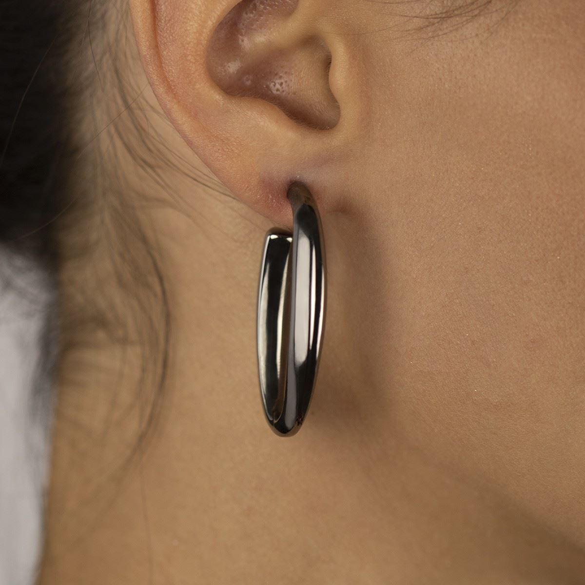 Oval earrings in ruthenium silver, triangular section, length 40mm